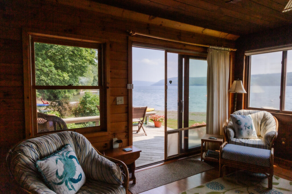 The cabin interior, with two armchairs and a sliding glass door open to the patio.