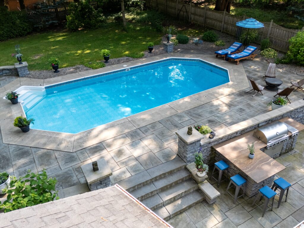 A backyard in-ground swimming pool.